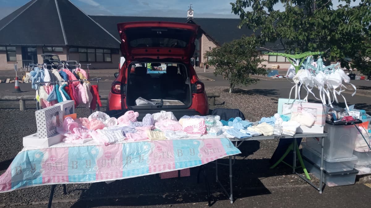 Seller stall beside a car at Lanark Market Car Boot Sale Source: https://www.lanark.co.uk/directory/business/lanark-market-car-boot-sale