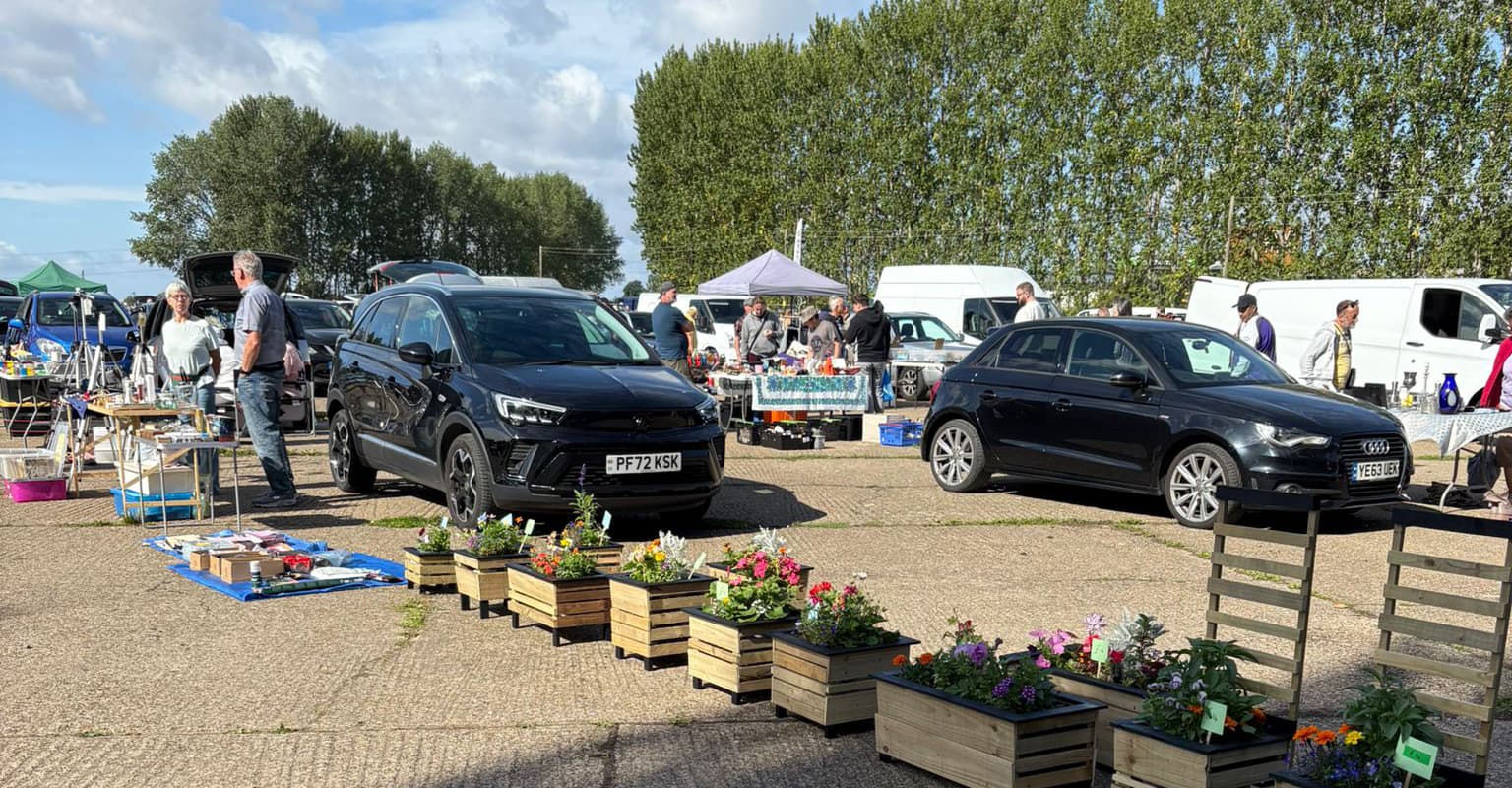 Cars, seller tables, goods and shoppers at Finmere Car Boot Sale on its hardstanding site. Source: https://www.finmerecarbootsale.co.uk/wp-content/uploads/2025/08/Finmere-1.jpg