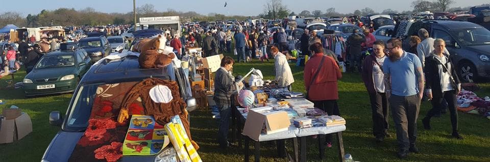 Busy A47 Car Boot Sale with cars, stalls, goods and shoppers across the field. Source: https://davidfreerevents.co.uk/wp-content/uploads/2023/01/70540010_10156381428052187_1688527797846278144_n.jpg