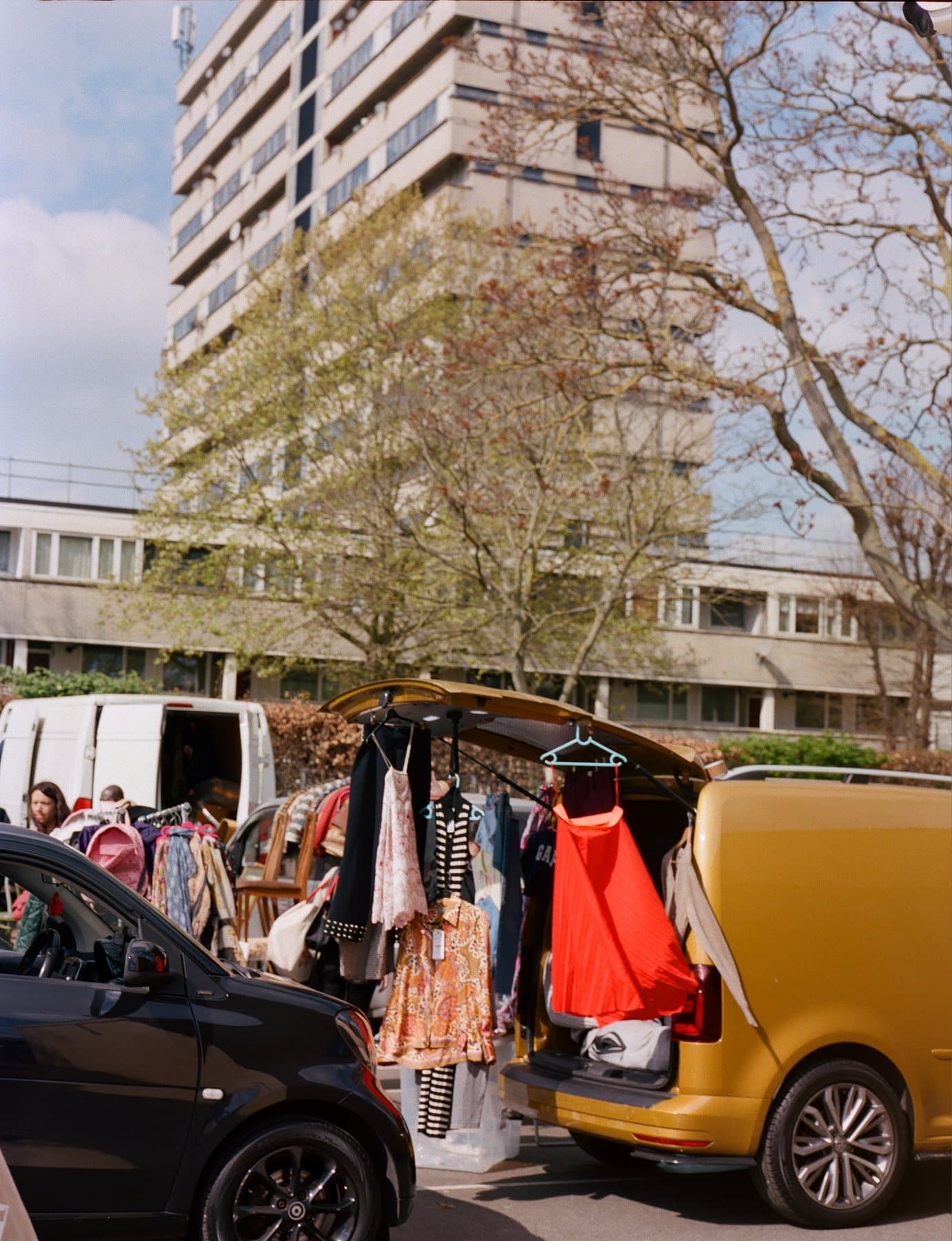 Clothing displayed from seller vehicles at Peckham Carboot. Photography by Betty Oxlade-Martin. Source: https://www.peckhamcarboot.com/gallery