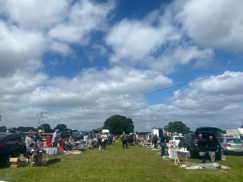 Wide view of cars, seller tables and shoppers across Redhill Car Boot field Source: https://eboots.co.uk/listing/redhill-car-boot-sale/