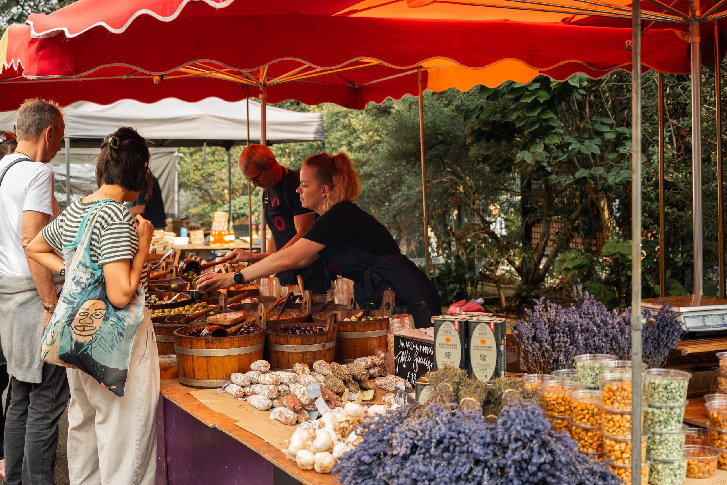 Shoppers choosing food from a produce stall at Primrose Hill Food Market. Source: http://www.primrosehillfoodmarket.co.uk