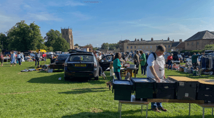 Busy Bedale Park car boot sale with cars, stalls, goods and shoppers Source: https://bedale-tc.gov.uk/uploads/pages/105/images/image.png
