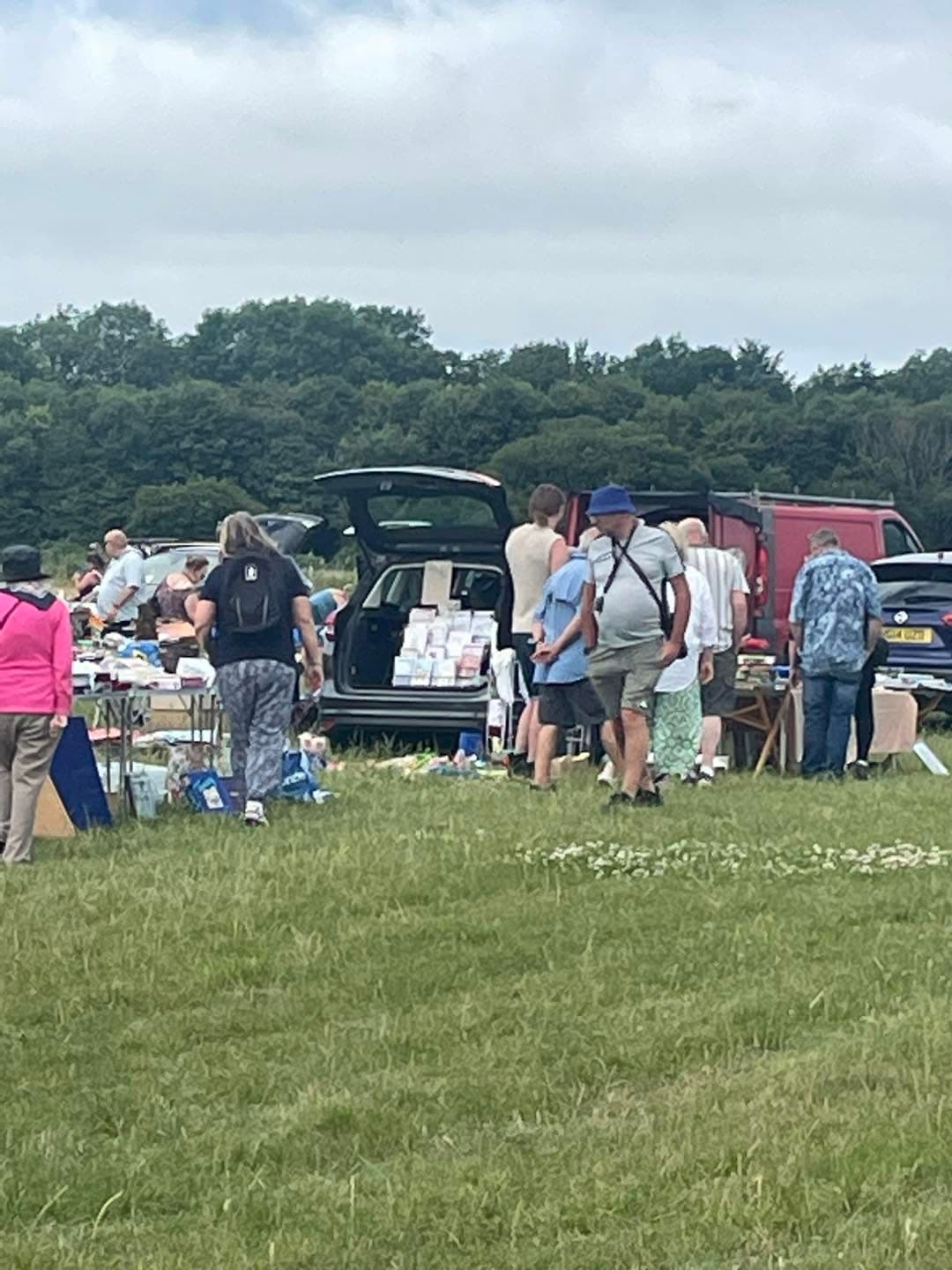 Puxton Hewish car boot with cars, tables, sellers and buyers on the grass Source: https://www.facebook.com/photo/?fbid=122195208440326196
