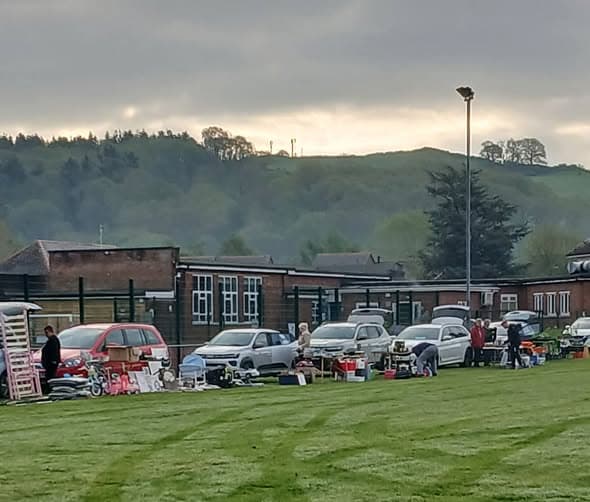 Cars, sellers and goods lined up on the field at Abermule Community Centre Car Boot Sale. Photo: Jane Rees via Abermule Community Noticeboard. Source: https://www.facebook.com/groups/271018743905098/posts/1686131982393760/