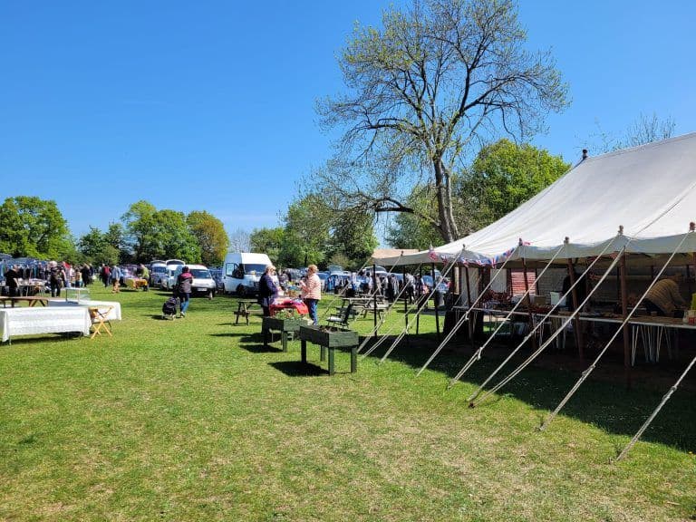 Shoppers browsing stalls and vehicles across the Elm Court playing-field car boot sale. Source: https://elmcourt.org.uk/car-boot-sales/