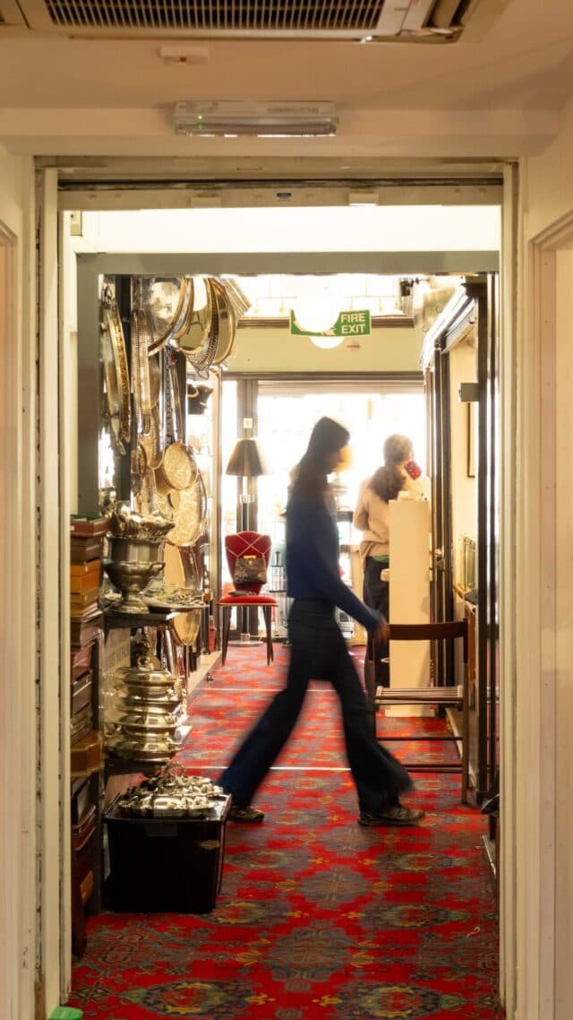 Shopper browsing antiques inside Alfies Antique Market Source: https://alfiesantiques.com/wp-content/uploads/sb-instagram-feed-images/720540258_18602864005026278_6719445308200519482_nfull.jpg