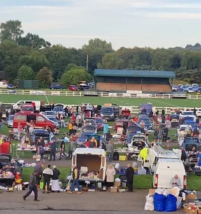Busy Blaydon Car Boot Sale with rows of cars, stalls, goods and shoppers at Crow Trees Source: https://blaydonrfc.co.uk/car-boot-sale/