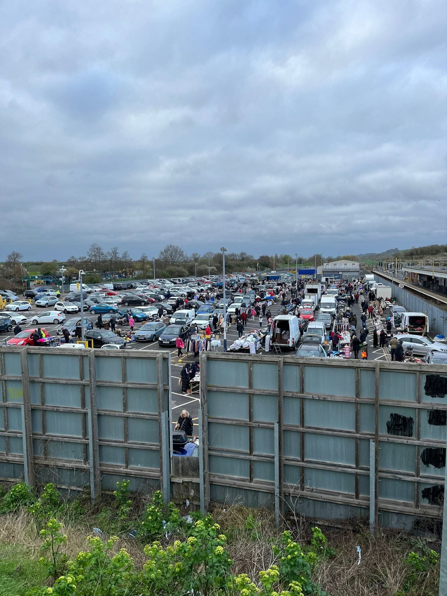 Busy Leigh Station car park filled with cars, seller pitches and shoppers at the Lazybones boot sale. Source: https://www.facebook.com/LazybonesUK1/photos/leigh-station-boot-sale-is-open-tomorrow-from-6am-barleylands-is-too-wet-after-t/698032045658120/