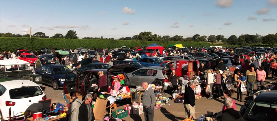 Lough Farm Car Boot with rows of sellers, cars and buyers Source: https://www.carlislecarboot.co.uk/slide/1.JPG