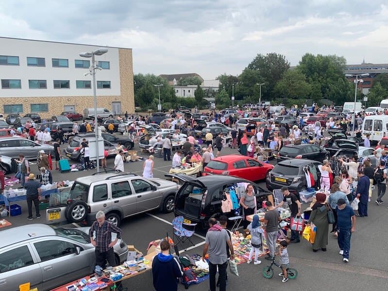 Busy Big Bettys Aylesbury car boot with rows of cars, tables, goods and shoppers at Aylesbury College. Source: https://www.bigbettys.co.uk/