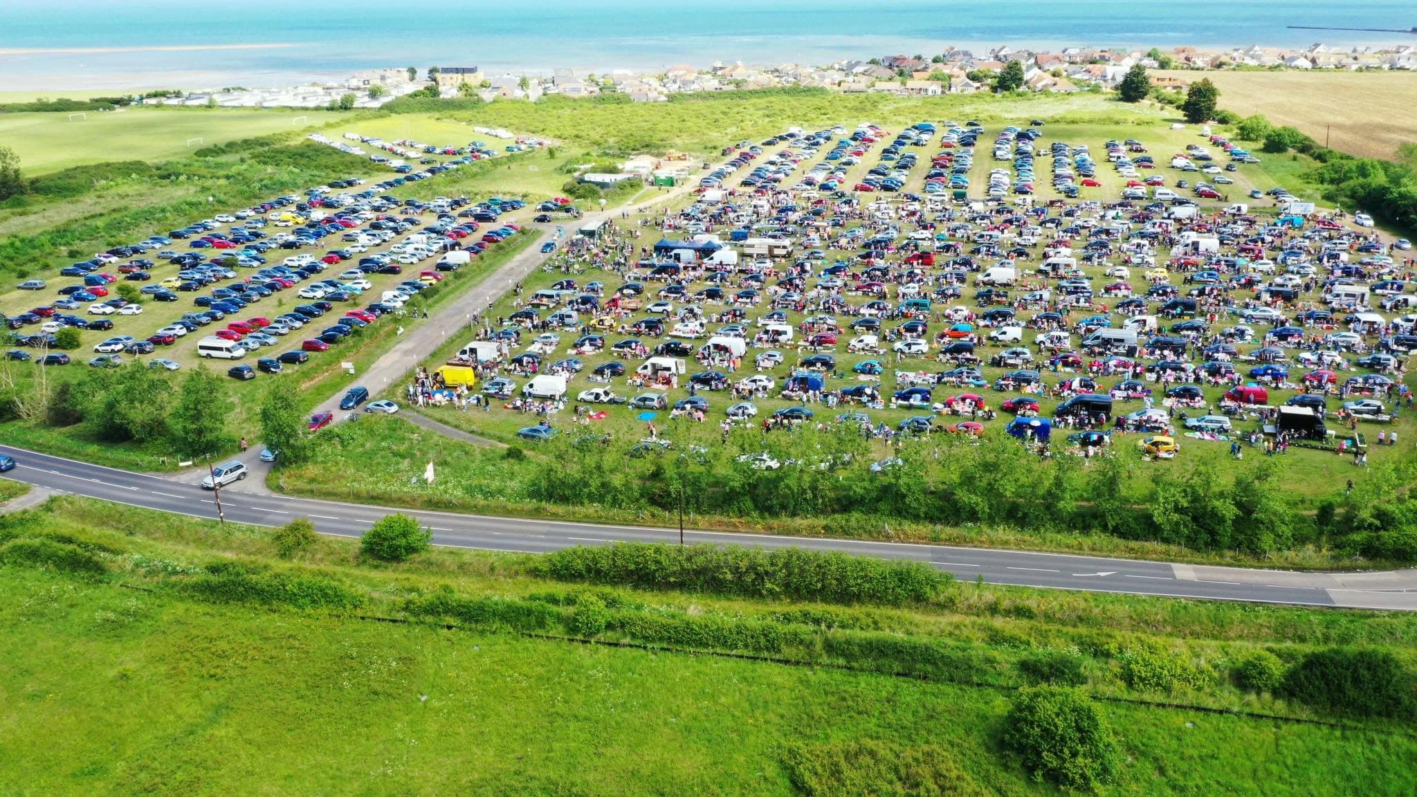 Aerial view of K&T Bootfairs on the Whitstable and Herne Bay bends, showing the full field of sellers, cars and shoppers. Source: https://www.facebook.com/photo/?fbid=1290642345529855