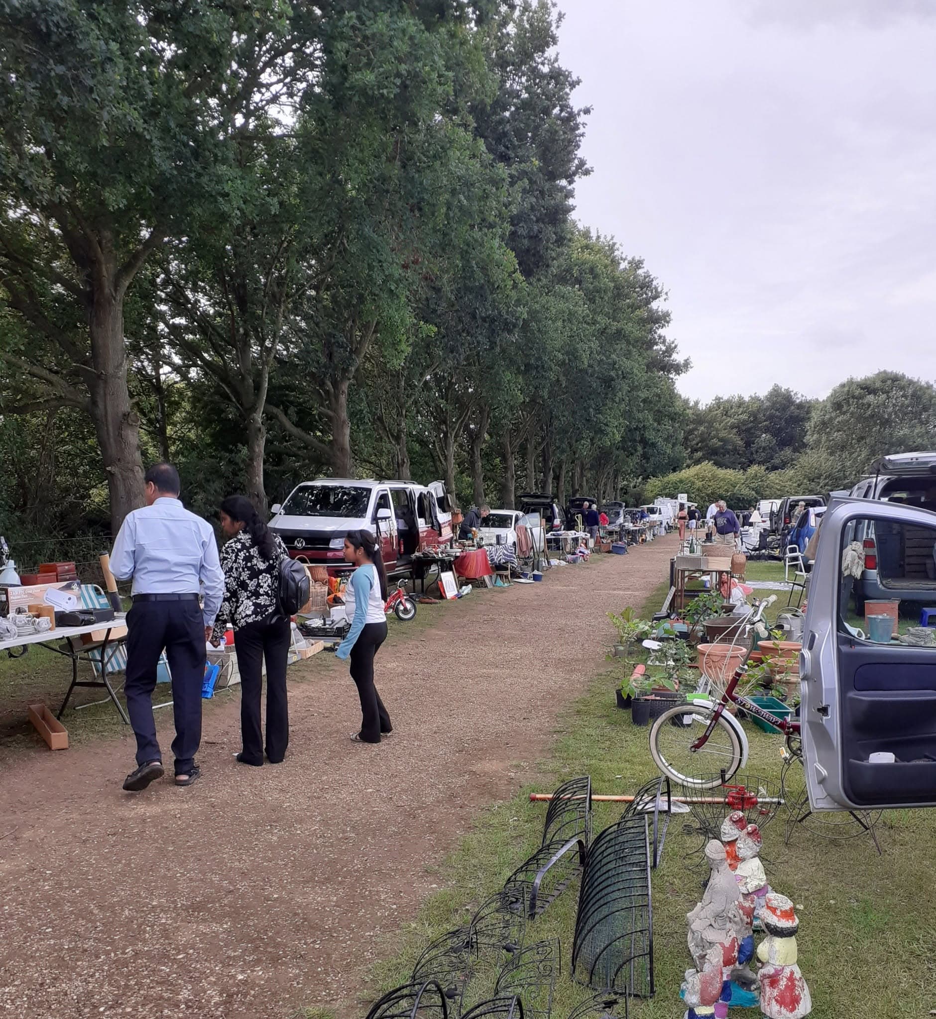 Cars, sellers and shoppers browsing rows of second-hand goods at Cherry Tree Car Boot in Fakenham Source: https://www.facebook.com/photo.php?fbid=1648137600648390&set=pb.100063564970918.-2207520000&type=3