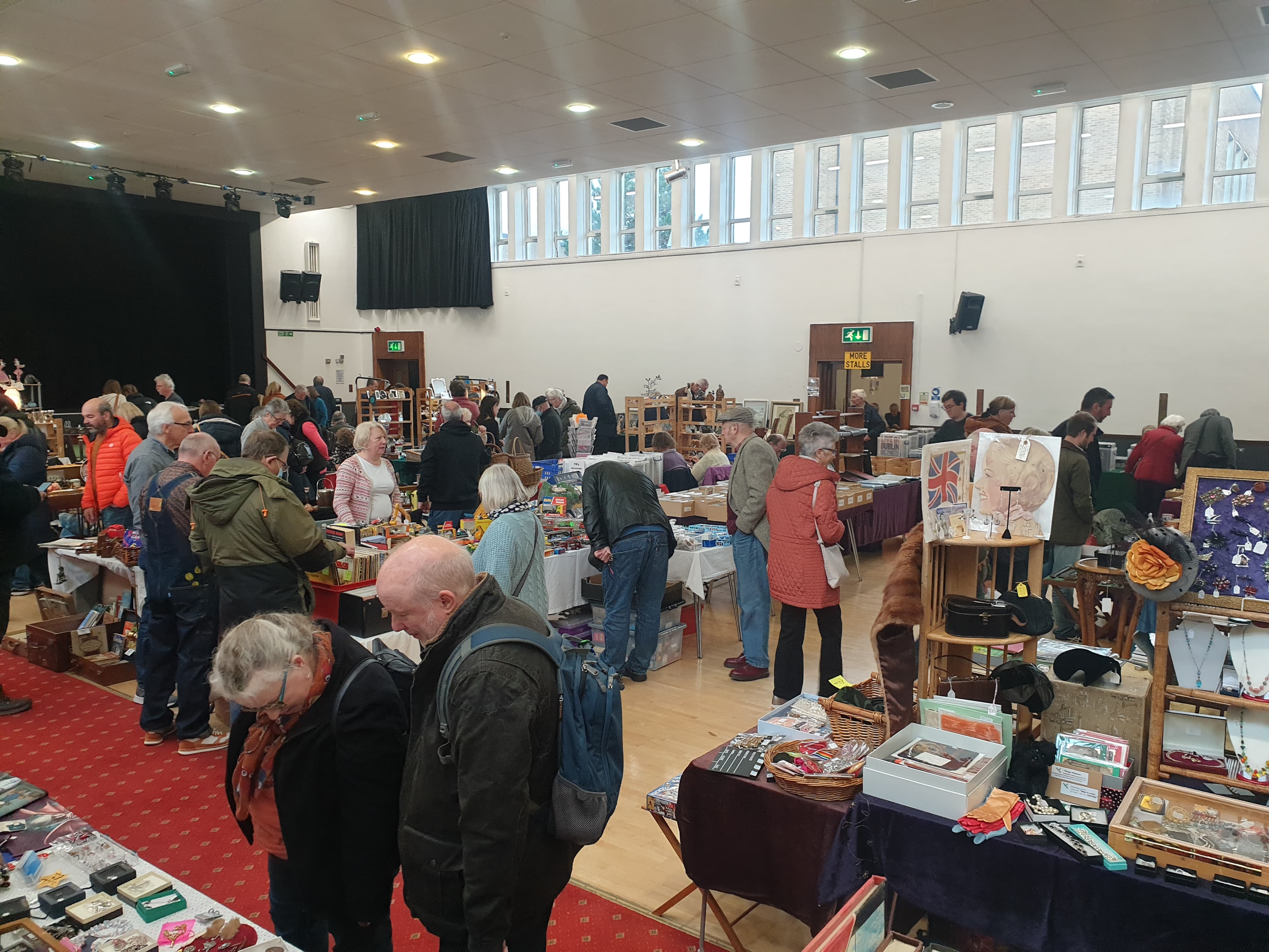 Shoppers browsing indoor antiques and collectors stalls at Benn Hall in Rugby