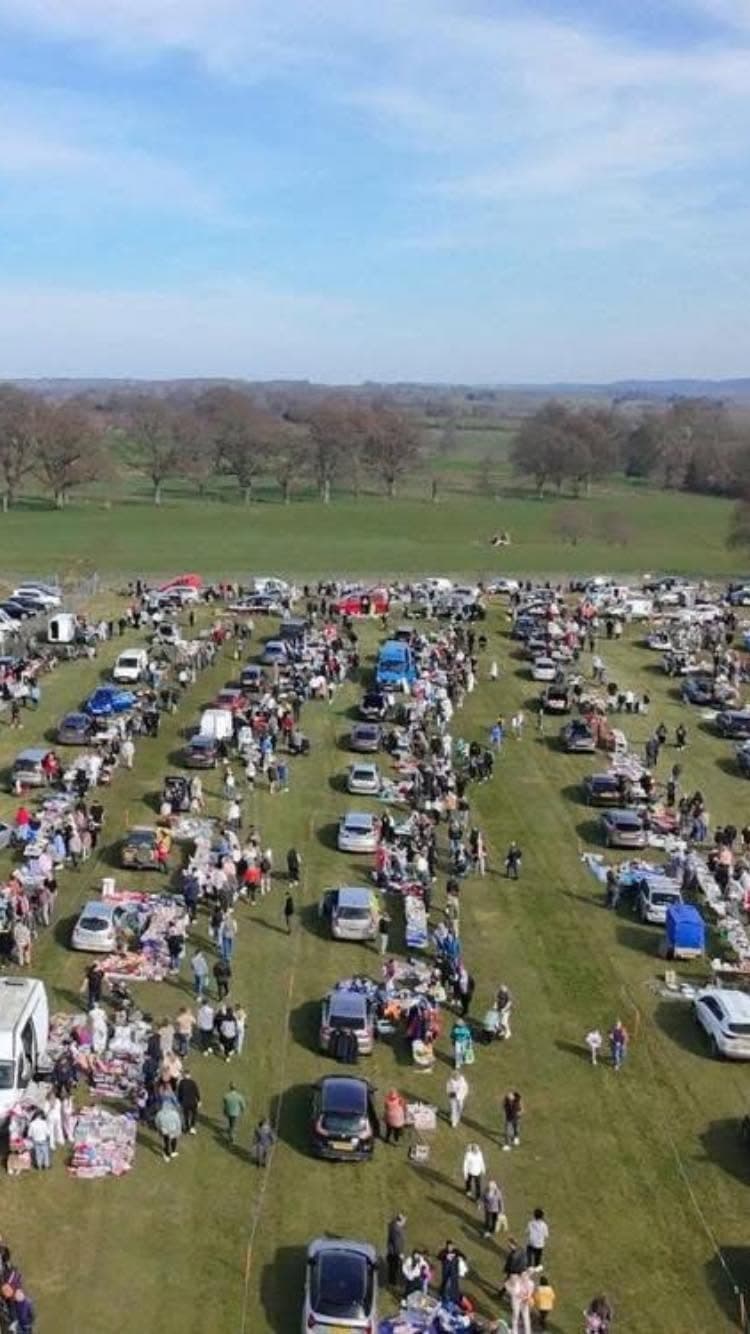 Aerial view of rows of cars, stalls and shoppers at Yeovil Showground Car Boot