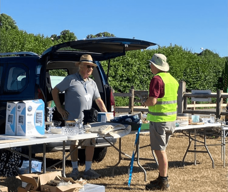 Sellers beside an open car boot and tables of second-hand goods at the Friends of the Yeatman Hospital car boot sale. Source: https://www.friendsoftheyeatman.org.uk/