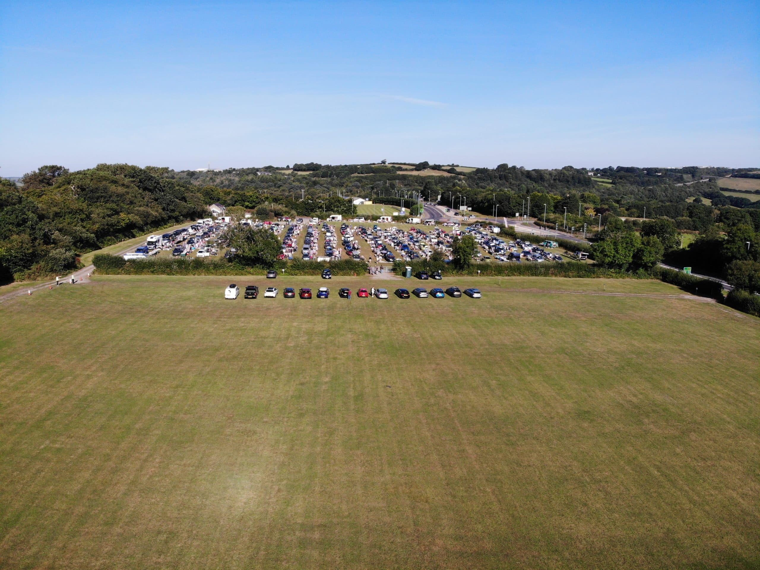 Aerial view of Lanhydrock Car Boot with rows of cars and stalls Source: https://www.lanhydrockcarboot.com/gallery/