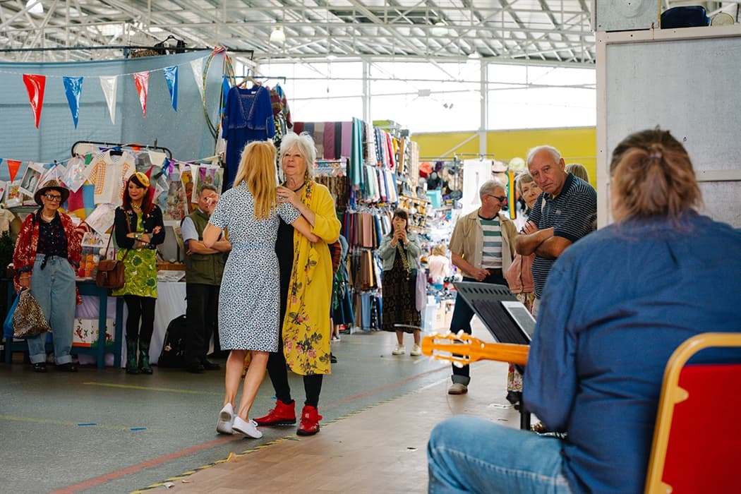 Shoppers and traders among colourful indoor stalls at Birmingham Rag Market. Source: https://visitbirmingham.com/listing/birmingham-rag-market/132562101/