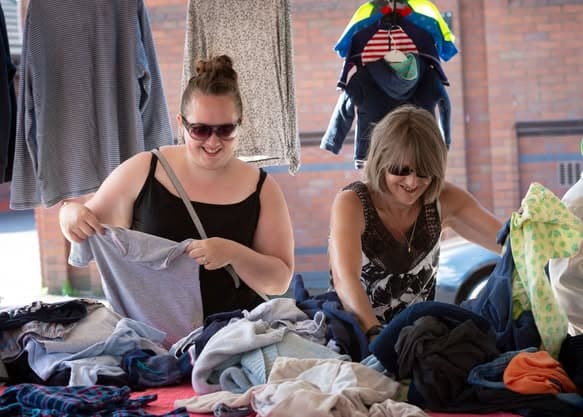 Shoppers browsing clothes at Tommyfield Market car boot Source: https://www.facebook.com/photo/?fbid=4198323466874179&set=pcb.4198323890207470
