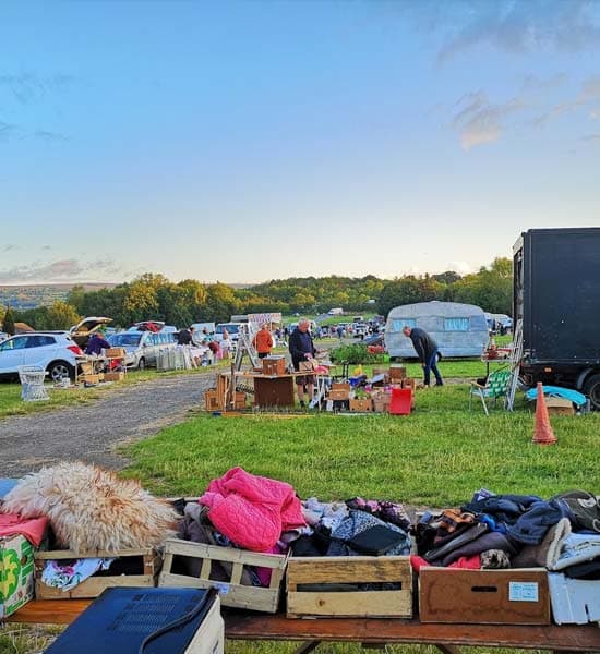 Cars, stalls, goods and shoppers at Chirk Giant Car Boot Sale Source: https://chirkcarboot.com/wp-content/uploads/2024/02/chirk-car-boot-sale-about-us.jpg