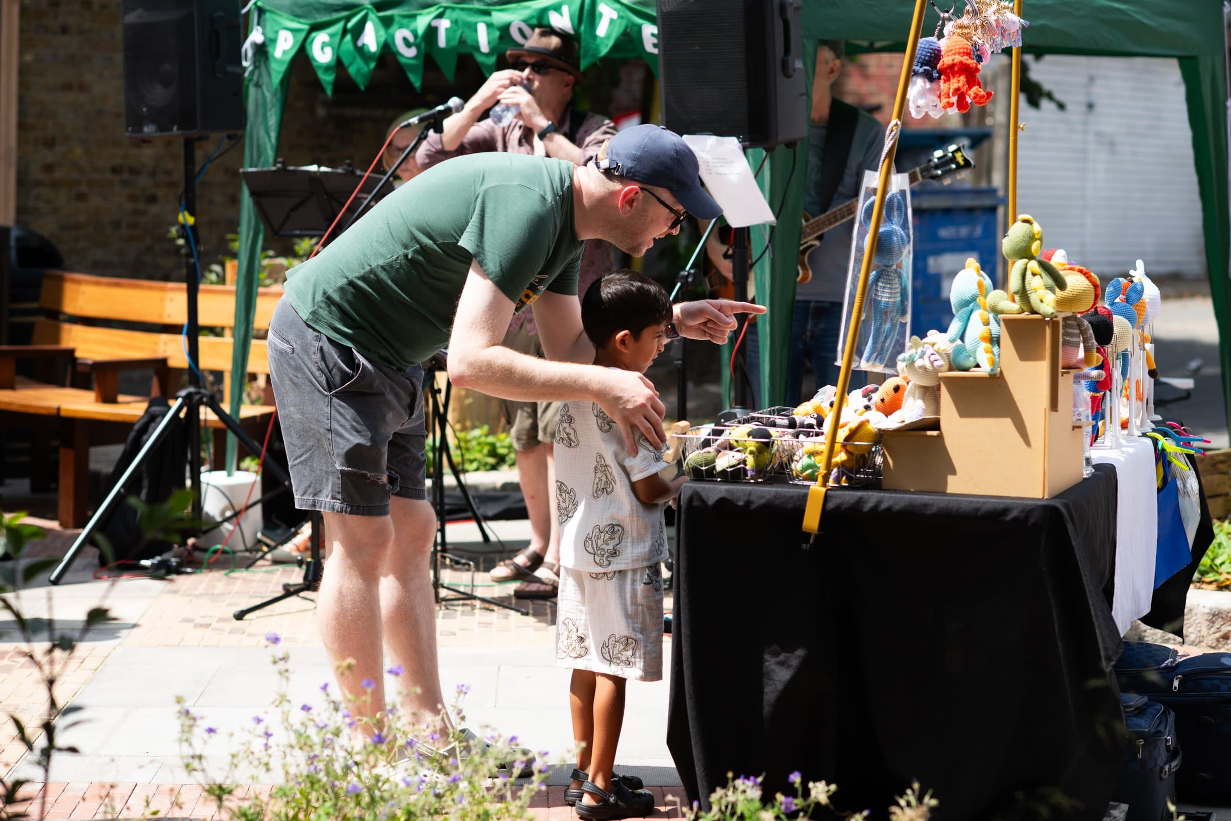A shopper and child browsing a craft stall at Palmers Green Community Market. Source: https://www.palmersgreenactionteam.org/streetmarkets