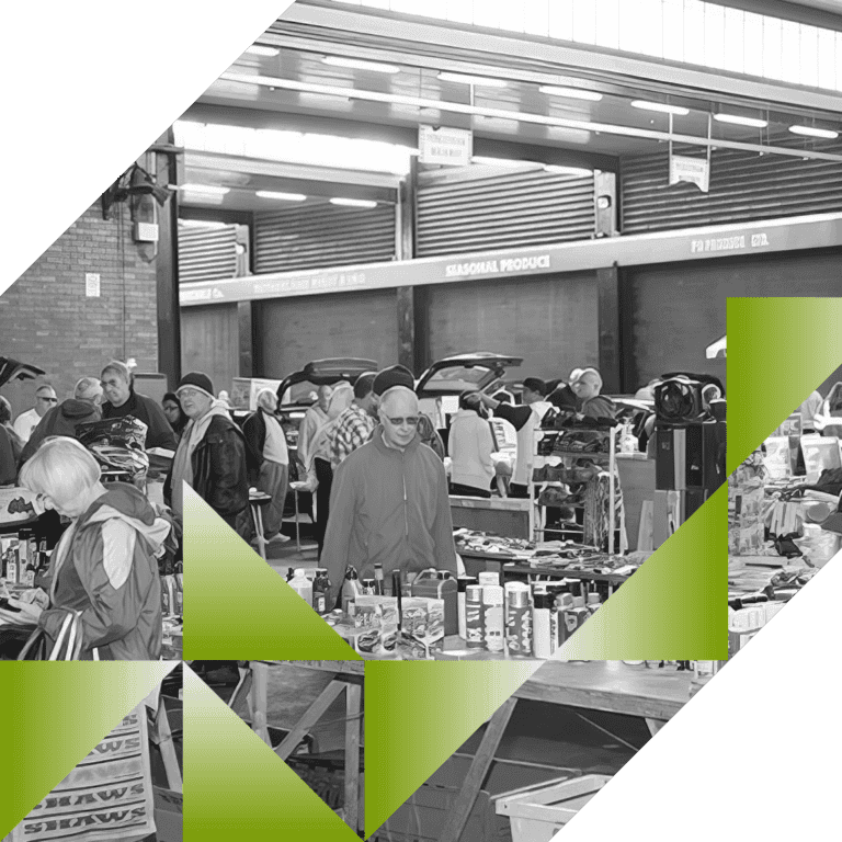 Shoppers browsing cars and tables at Blochairn Car Boot Sale inside the market depot Source: https://www.citypropertyglasgow.co.uk/markets/car-boot/