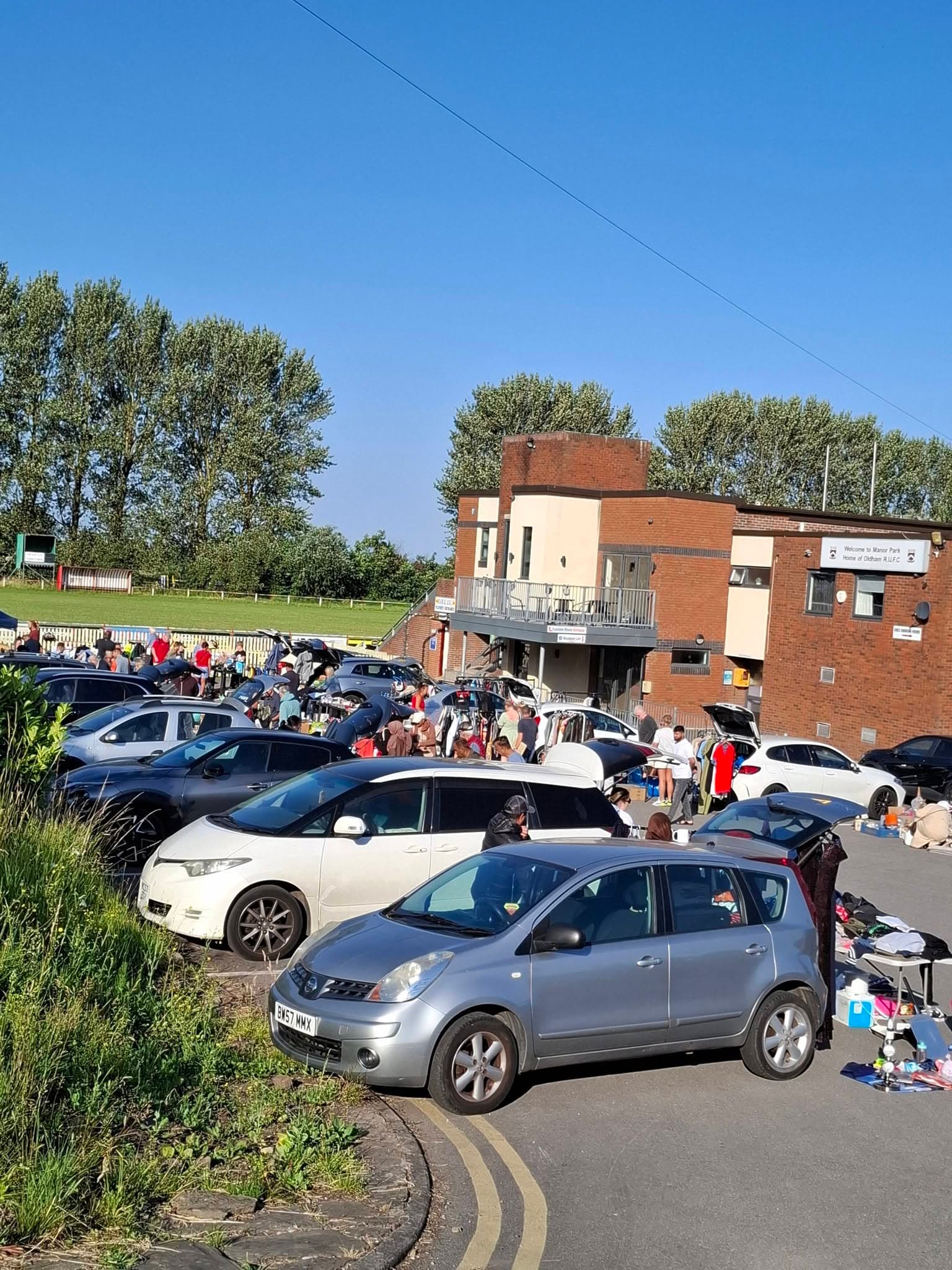 Cars, tables of goods and shoppers at Oldham Rugby Union Car Boot Sale. Source: https://www.facebook.com/photo.php?fbid=1512744853987613
