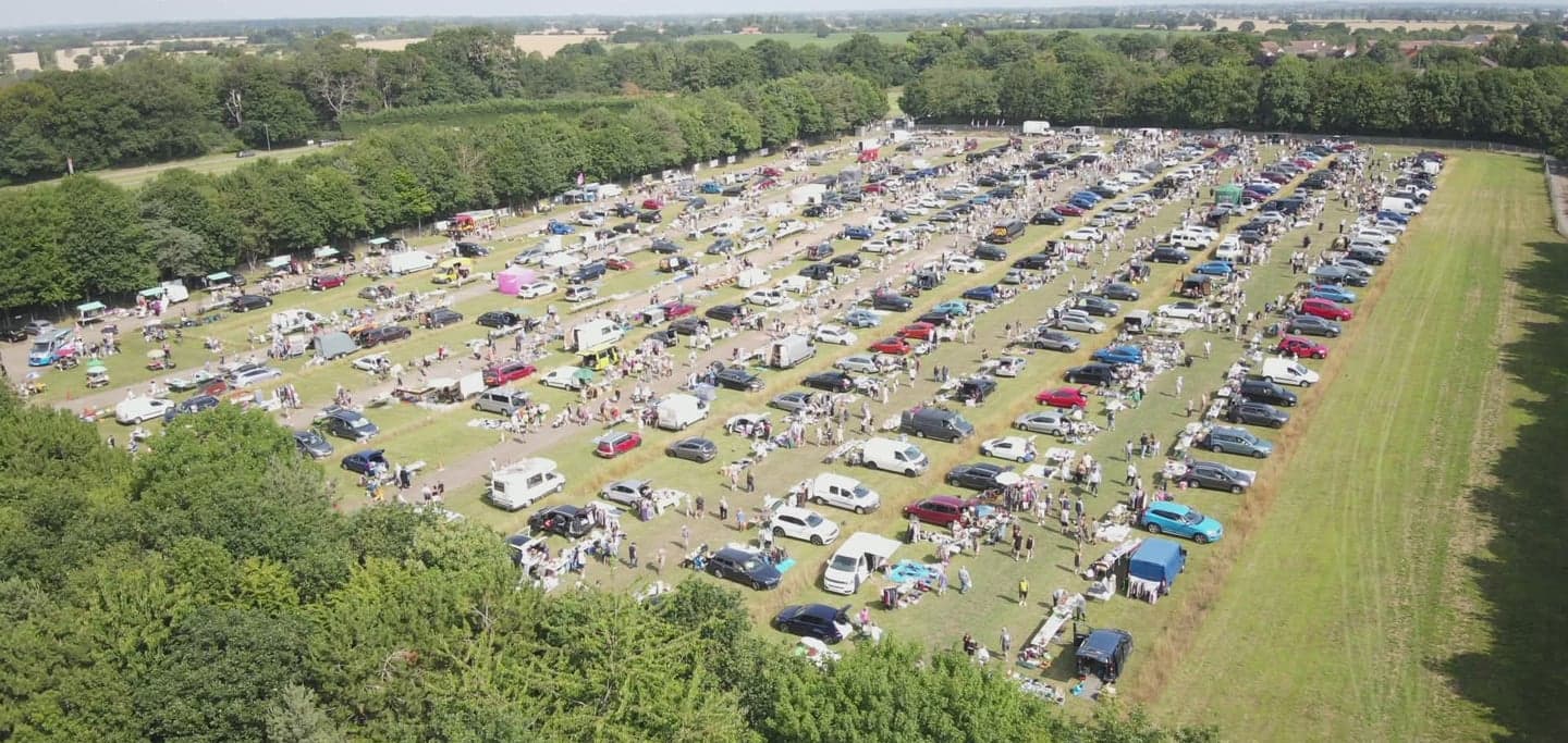 Aerial view of Kessingland Carboot and Market with rows of cars, stalls and shoppers across the field. Source: https://kessinglandcarbootmarket.co.uk/
