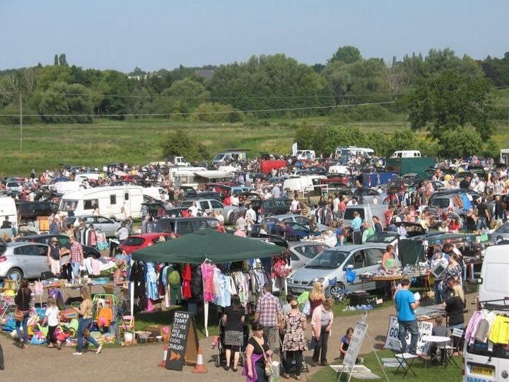 Exact organizer-gallery photo showing a busy Arminghall sale with cars, stalls, sellers and shoppers. Source: https://storage.googleapis.com/wzukusers/user-21244421/images/56ea699f60276LRbdwZa/image.jpg