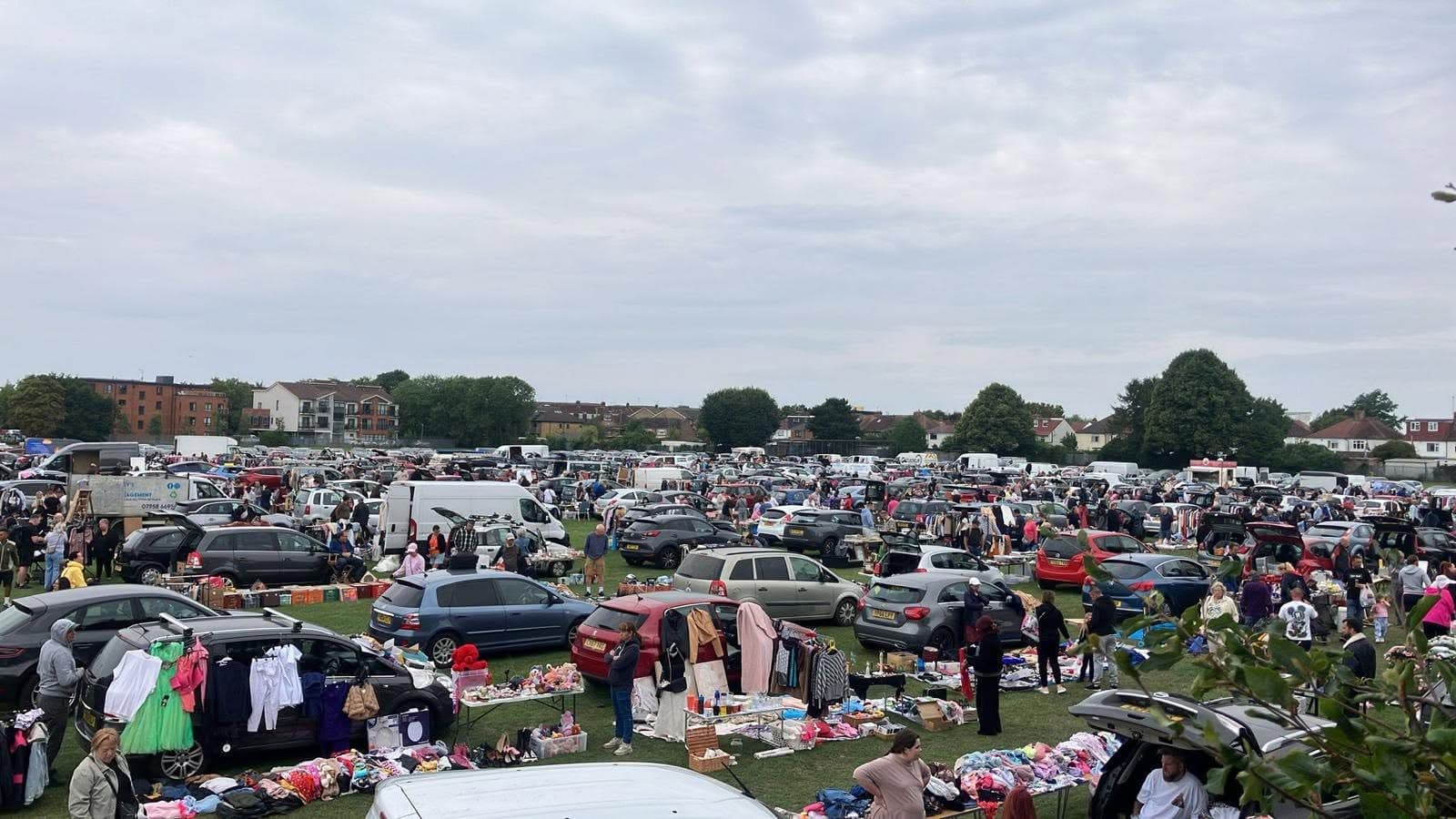 A large Uxbridge car boot sale with rows of cars, tables, clothes and shoppers Source: https://www.facebook.com/photo.php?fbid=1345848267540731