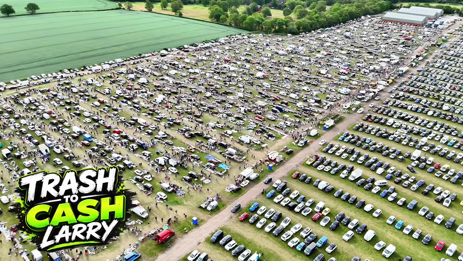 Aerial view of Pedham Place Gigantic Super Boot Sale with rows of cars, stalls and shoppers. Attribution: Trash To Cash Larry. Source: https://www.youtube.com/watch?v=0eEZ-segsmQ
