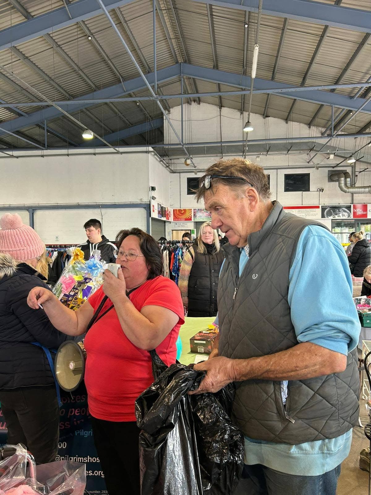 Exact organizer photo of shoppers browsing goods inside Ashford Market hall. Source: https://www.facebook.com/photo/?fbid=989641240062053