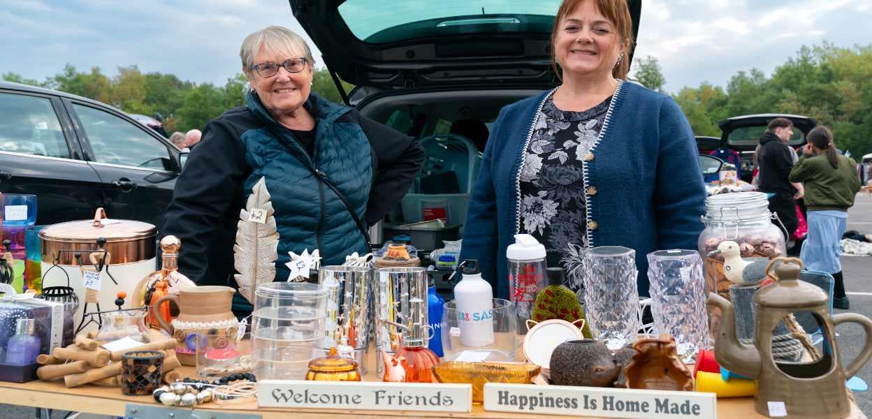 Bowlee sellers with second-hand goods beside their cars Source: https://www.rochdale.gov.uk/images/Bowlee_2026_main_1248_x_600.jpg