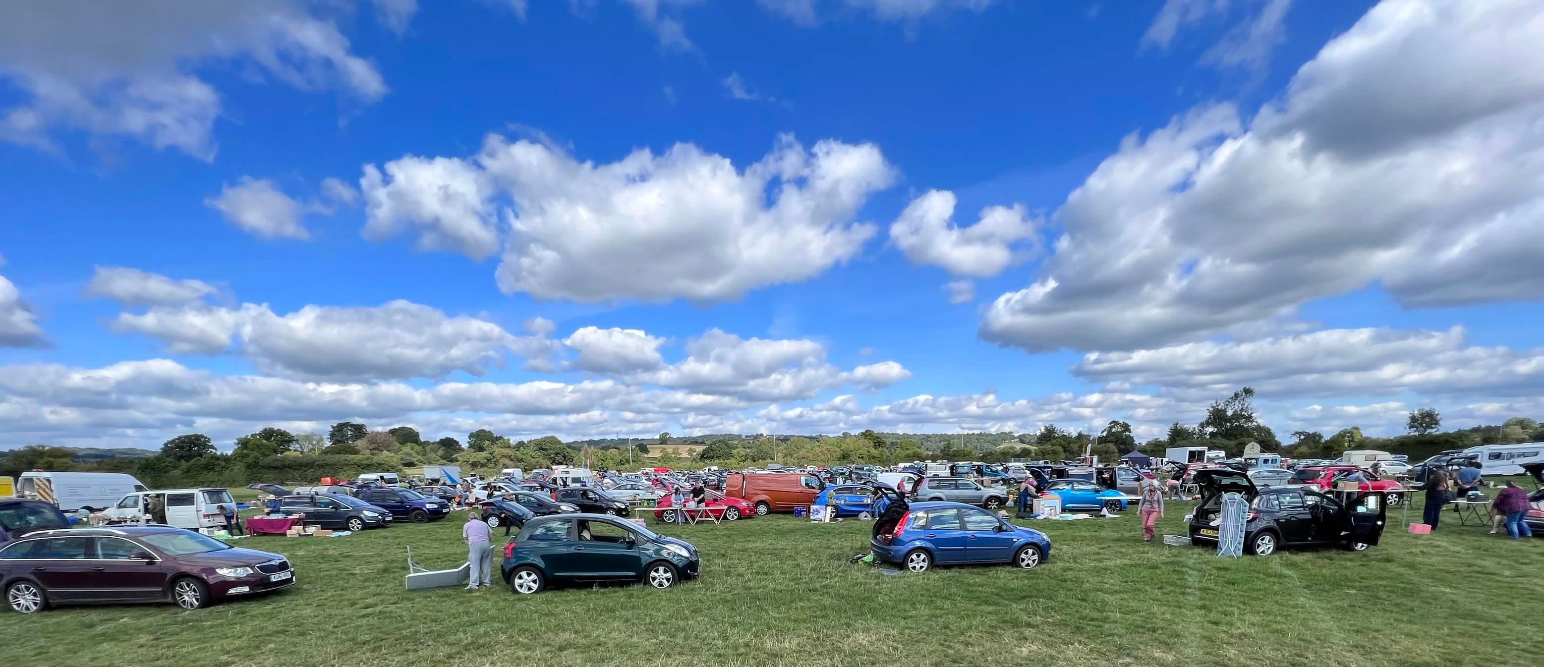 Cars, vans, seller pitches and shoppers spread across Axminster Showground car boot sale. Source: https://www.facebook.com/photo/?fbid=499902062144399