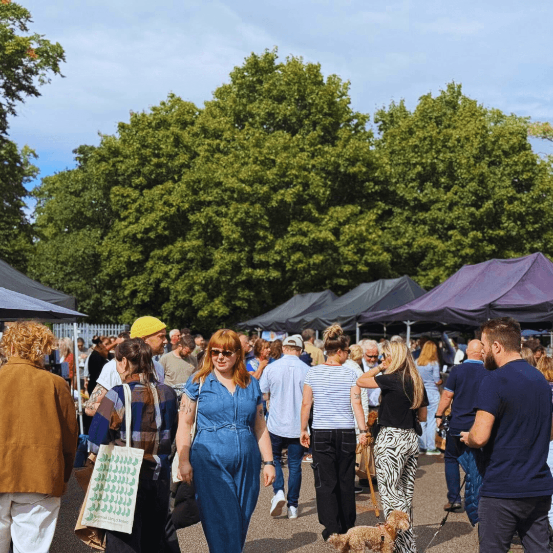 Shoppers browsing rows of outdoor stalls at West Didsbury Makers Market. Source: https://www.themakersmarket.co.uk/venue/west-didsbury/