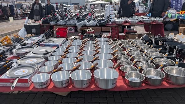 Cookware, shoes and shoppers at Western International Sunday Market Source: https://www.facebook.com/photo/?fbid=1469146301905432&set=pcb.1469147885238607