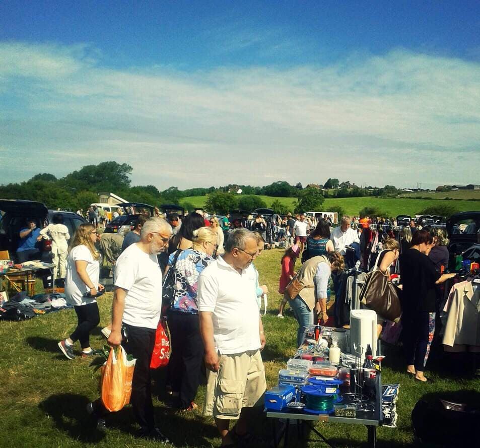 Shoppers browsing tables and open car boots at Shoreham Flyover Car Boot Sale Source: https://www.findcarboot.co.uk/shoreham-flyover-car-boot-sale/