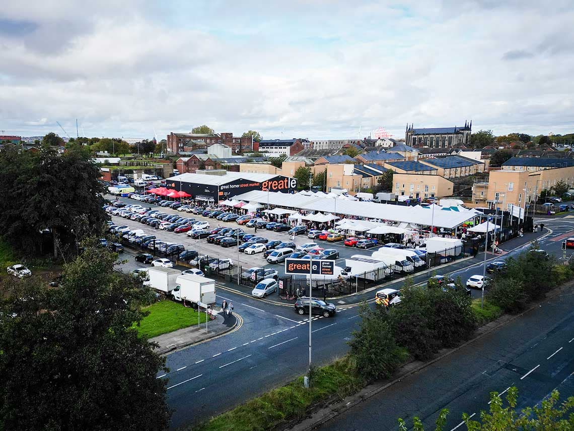 Official aerial view of Great Homer Street Market showing its indoor and outdoor stalls, canopies and visitor parking. Source: https://liverpool.gov.uk/media/vljddvvi/markets-greatie-5-1140.jpg