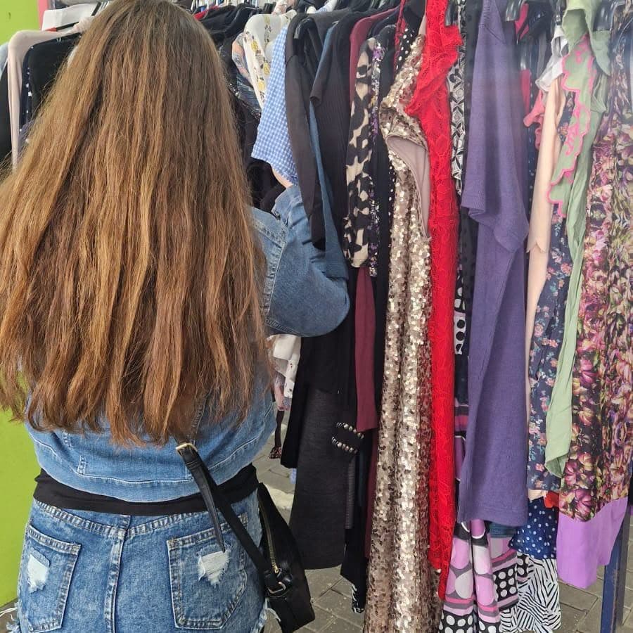 Shopper browsing a second-hand clothing rail at Maidstone Market and Boot Fair Source: https://www.facebook.com/photo.php?fbid=1554520819797846