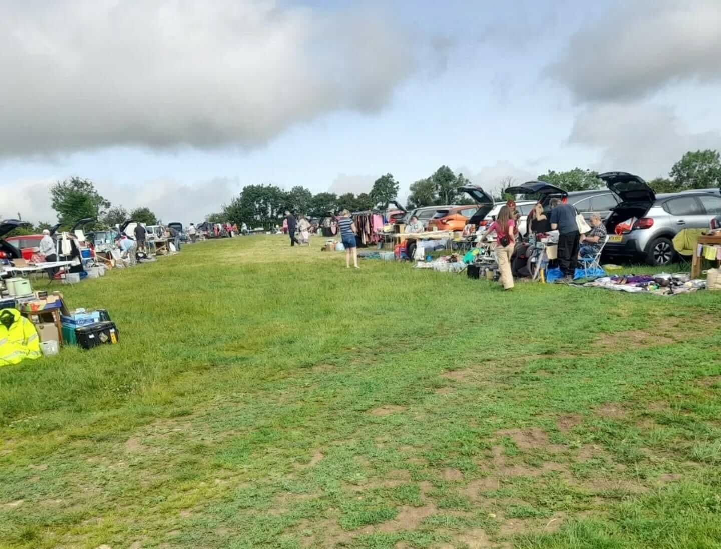 Kimbers Farm Shop car boot sale with rows of sellers and cars Source: https://www.findcarboot.co.uk/kimbers-farm-shop-car-boot-sale/