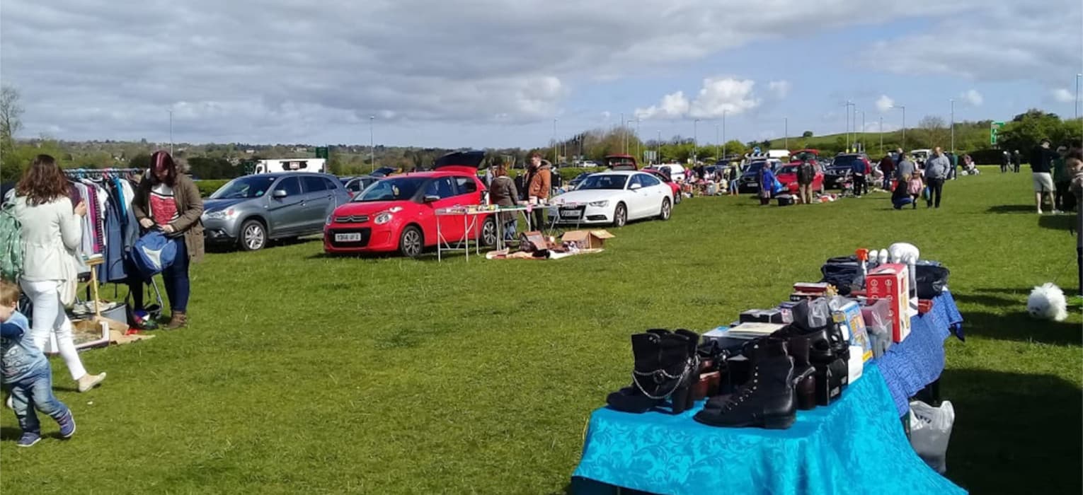 Cars, seller tables and shoppers spread across the field at Pannal Car Boot Sale. Source: https://pannalcarbootsale.co.uk/wp-content/uploads/2020/09/pannel_home_slide.jpg
